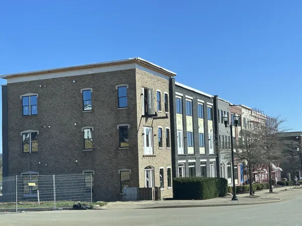 a view of a brick building next to a road