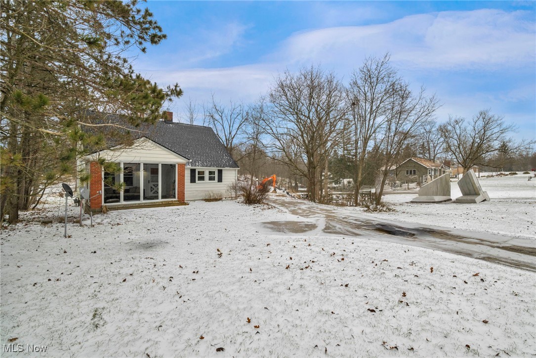 Front of home w/ramp, two entrances (front & side) paved driveway, 2 car detached garage