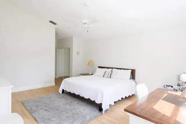 a bedroom with a bed and a night stand