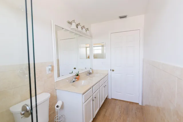 a bathroom with a double vanity sink and mirror