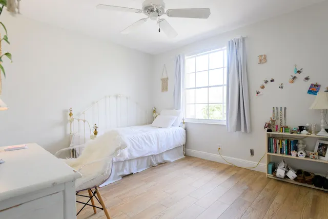 a spacious bedroom with a bed and a window