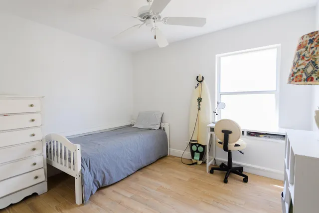 a bedroom that has a bed and a chandelier