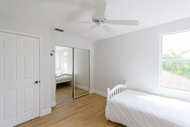 a bedroom with a bed and a window