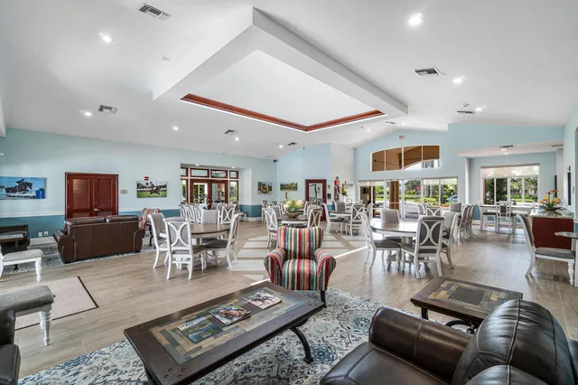 a living room with furniture a rug and a table