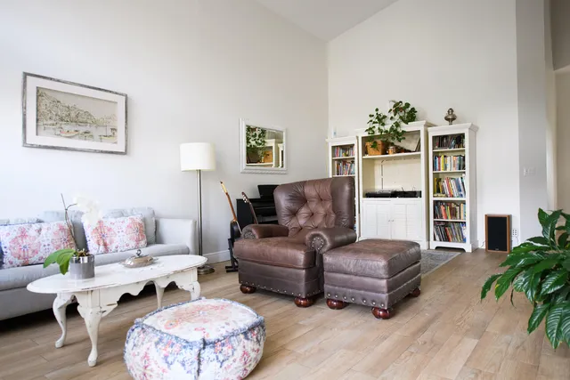 a living room with furniture and a potted plant