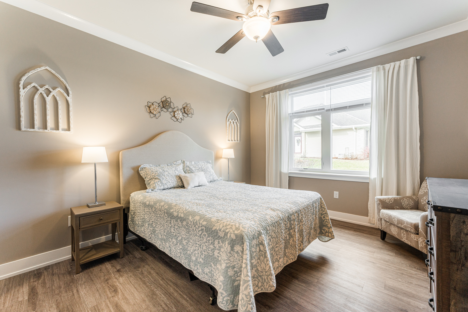 108 Boulder Court, Unit 108 Genoa, IL 60135 - Photo 13 of 25 a bedroom with a bed and a chandelier