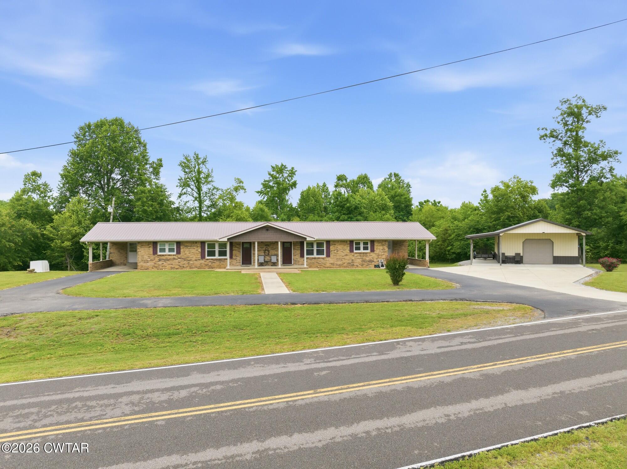 944 Brooksie Thompson Road Decaturville, TN 38329 - Photo 35 of 47 a front view of a house with a big yard