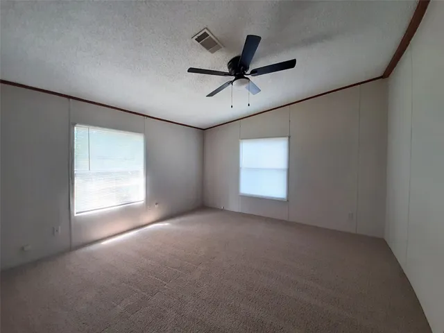 a view of a livingroom with a ceiling fan and window