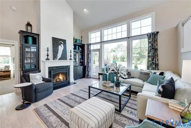 a living room with furniture large window and a fireplace