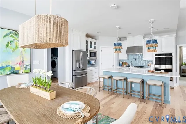 a living room with stainless steel appliances kitchen island granite countertop furniture and a kitchen view