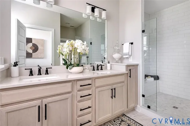 a bathroom with a shower sink and mirror