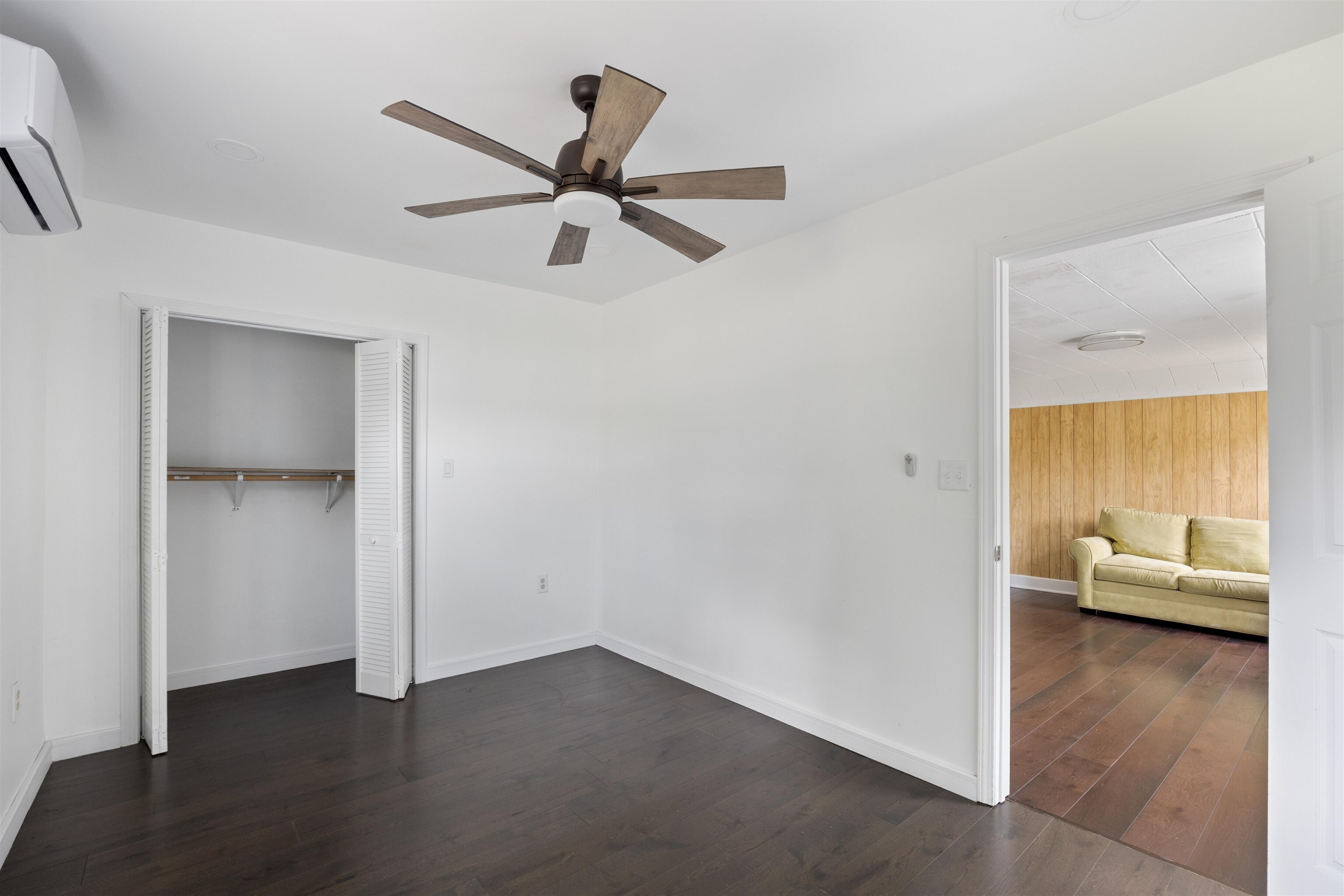 112 South Juniper Street Foley, AL 36535 - Photo 11 of 64 Unfurnished bedroom with dark wood-type flooring, ceiling fan, and a closet