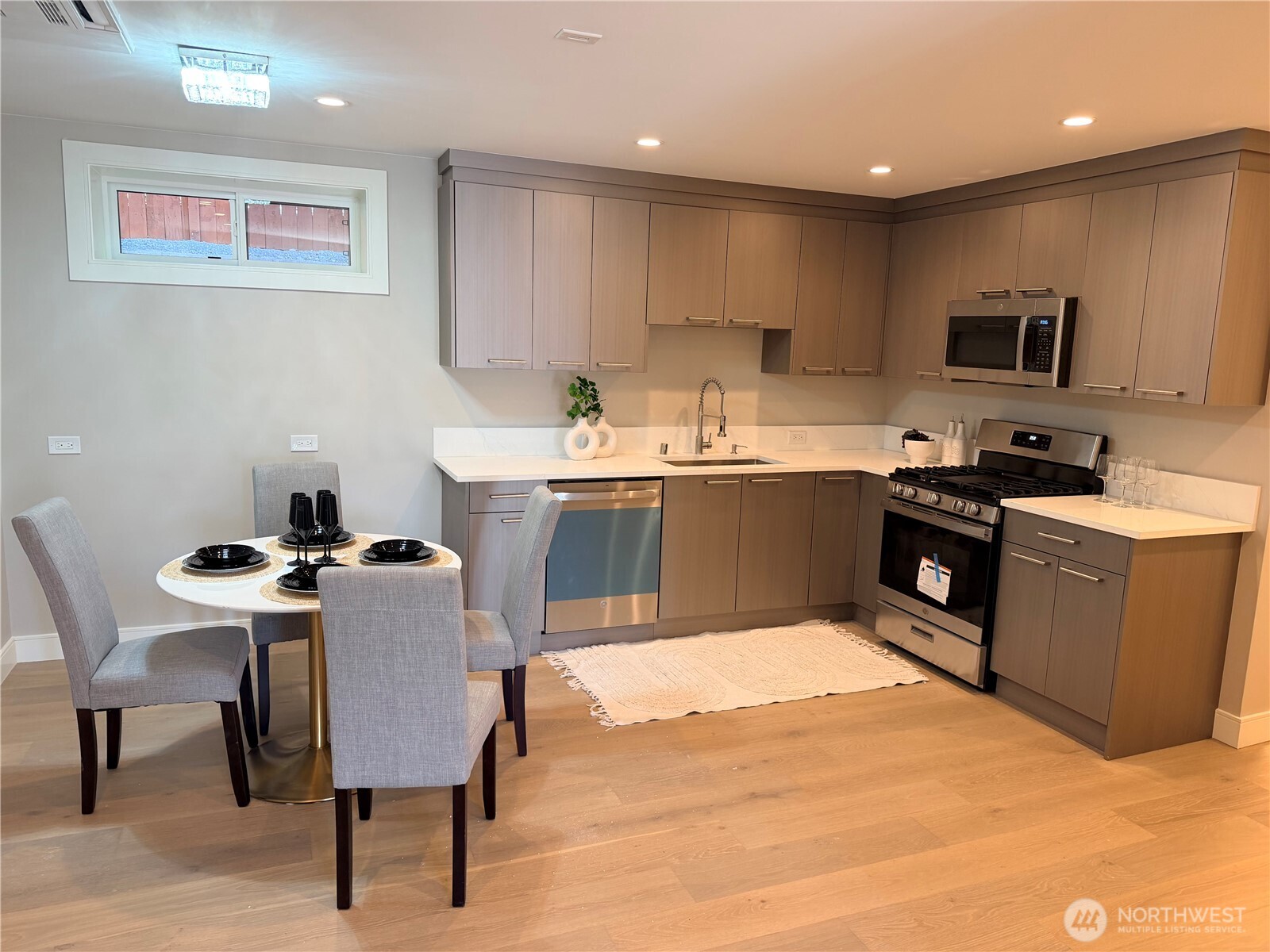 4305 Northeast 26th Court Renton, WA 98059 - Photo 35 of 40 a kitchen with a table chairs sink and cabinets