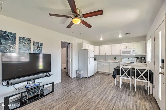 a living room with dining room and wooden floor