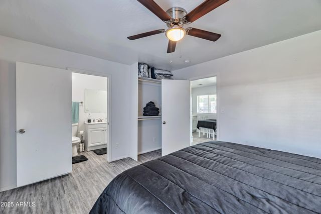 a bedroom with a large bed and a chandelier