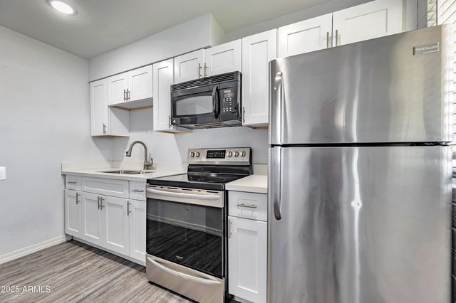 a white refrigerator freezer sitting inside of a kitchen