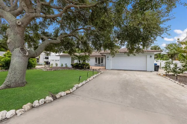 a view of a swimming pool with a patio and a garden