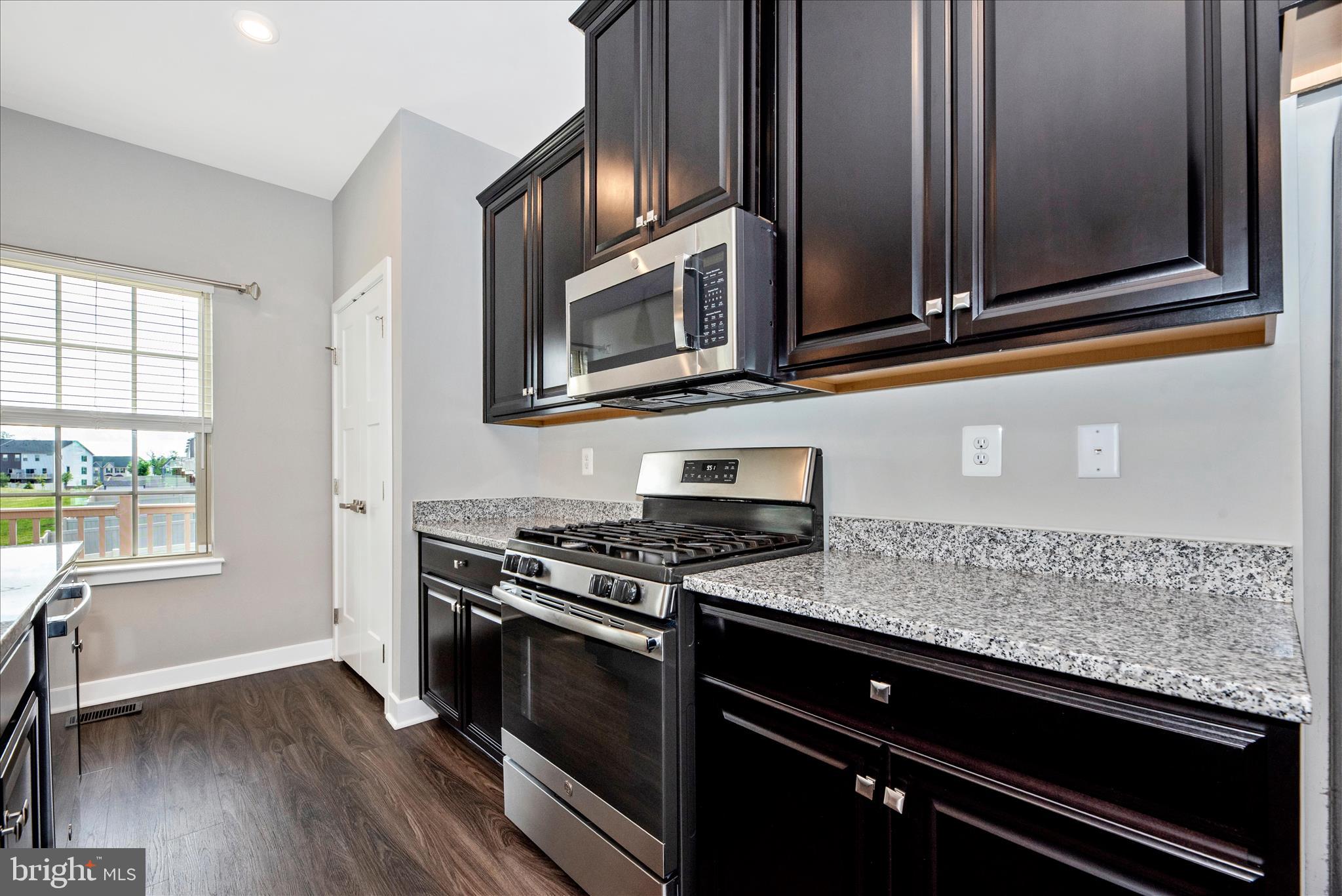 7091 Kokanee Way New Market, MD 21774 - Photo 21 of 69 a kitchen with granite countertop cabinets stainless steel appliances and a window