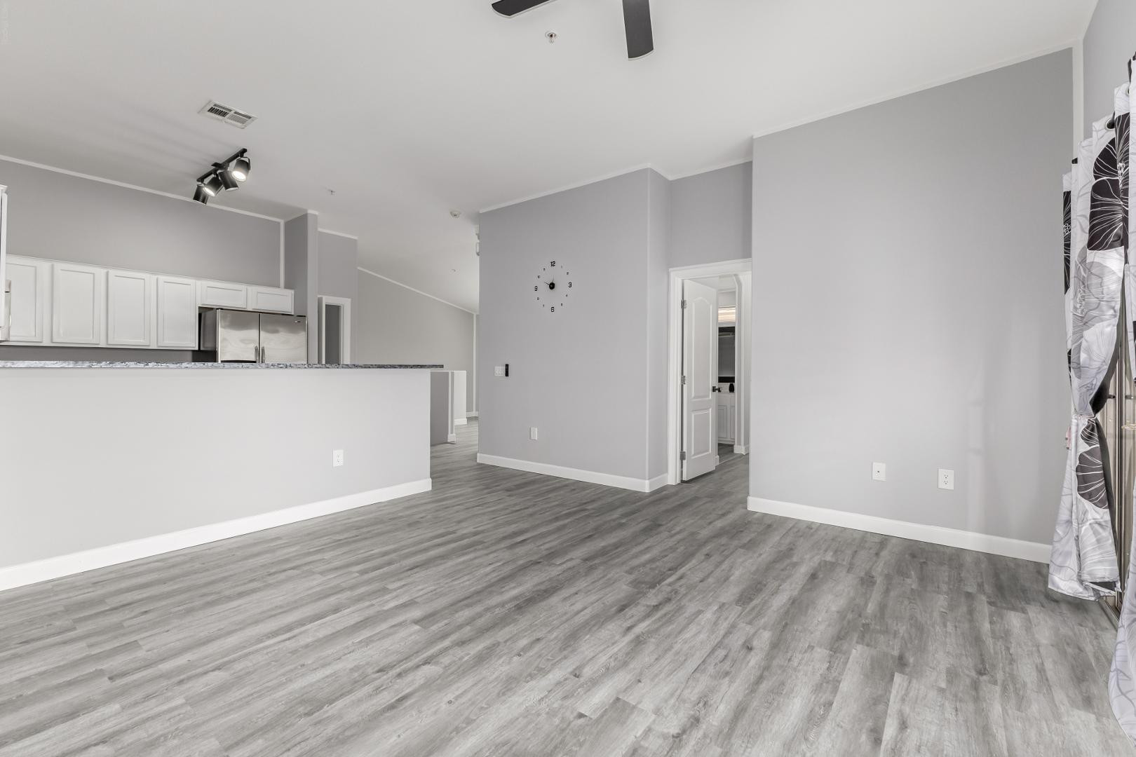 1350 South Greenfield Road, Unit 2205 Mesa, AZ 85206 - Photo 7 of 42 a view of a kitchen with wooden floor and a ceiling fan