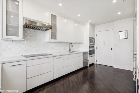 a kitchen with a refrigerator and white stove top oven