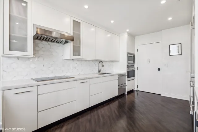 a kitchen with a refrigerator and white stove top oven