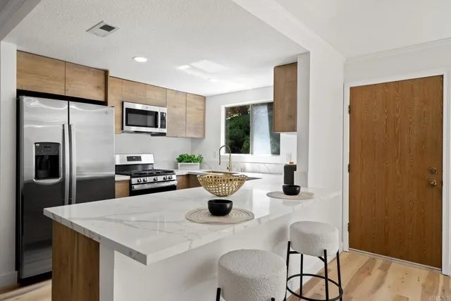 a kitchen with a table chairs refrigerator and microwave