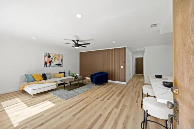 a bedroom with furniture and wooden floor