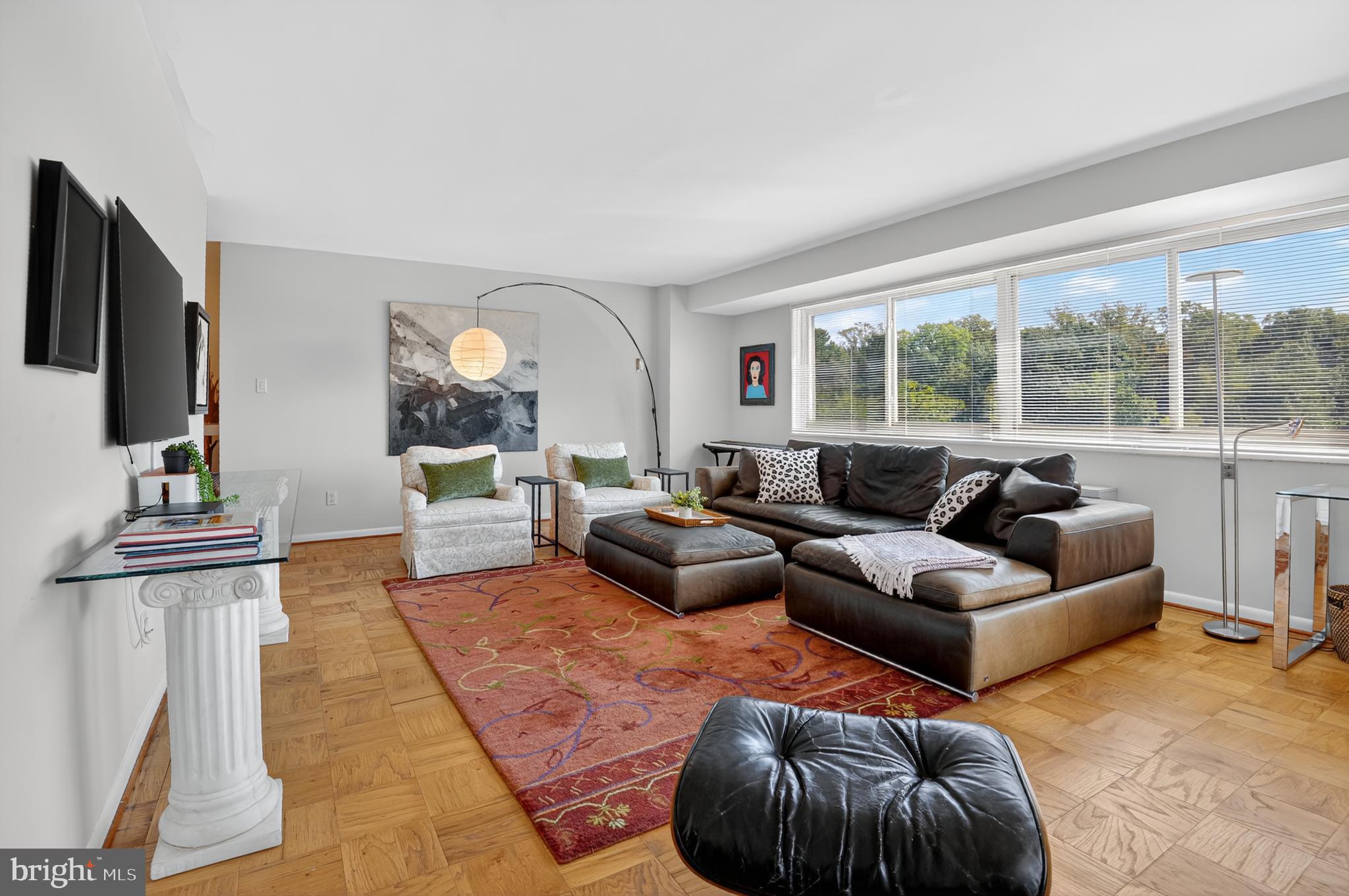 5100 Dorset Avenue, Unit 314 Chevy Chase, MD 20815 - Photo 13 of 30 a living room with furniture and a flat screen tv
