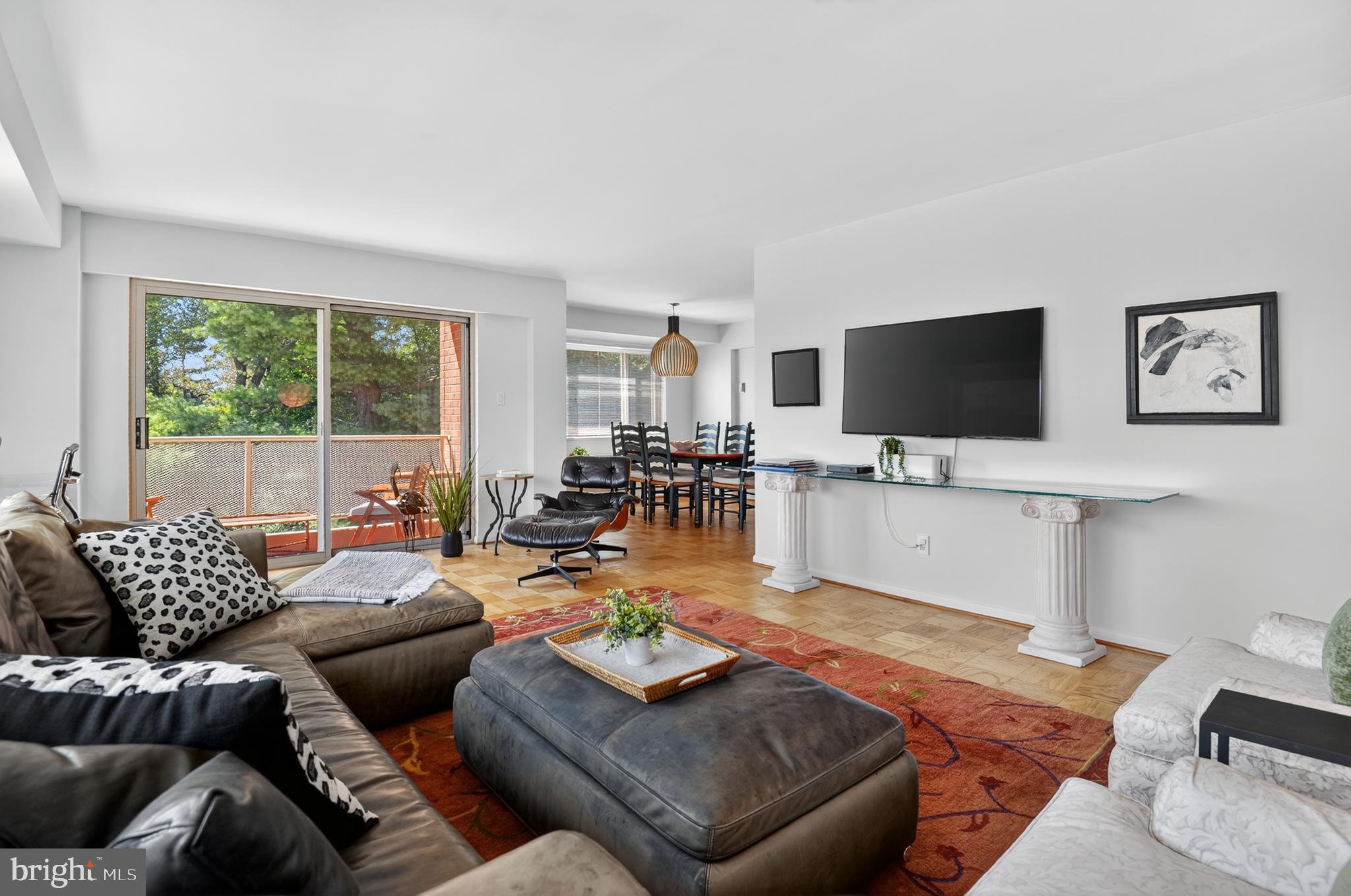 5100 Dorset Avenue, Unit 314 Chevy Chase, MD 20815 - Photo 14 of 30 a living room with furniture and a flat screen tv