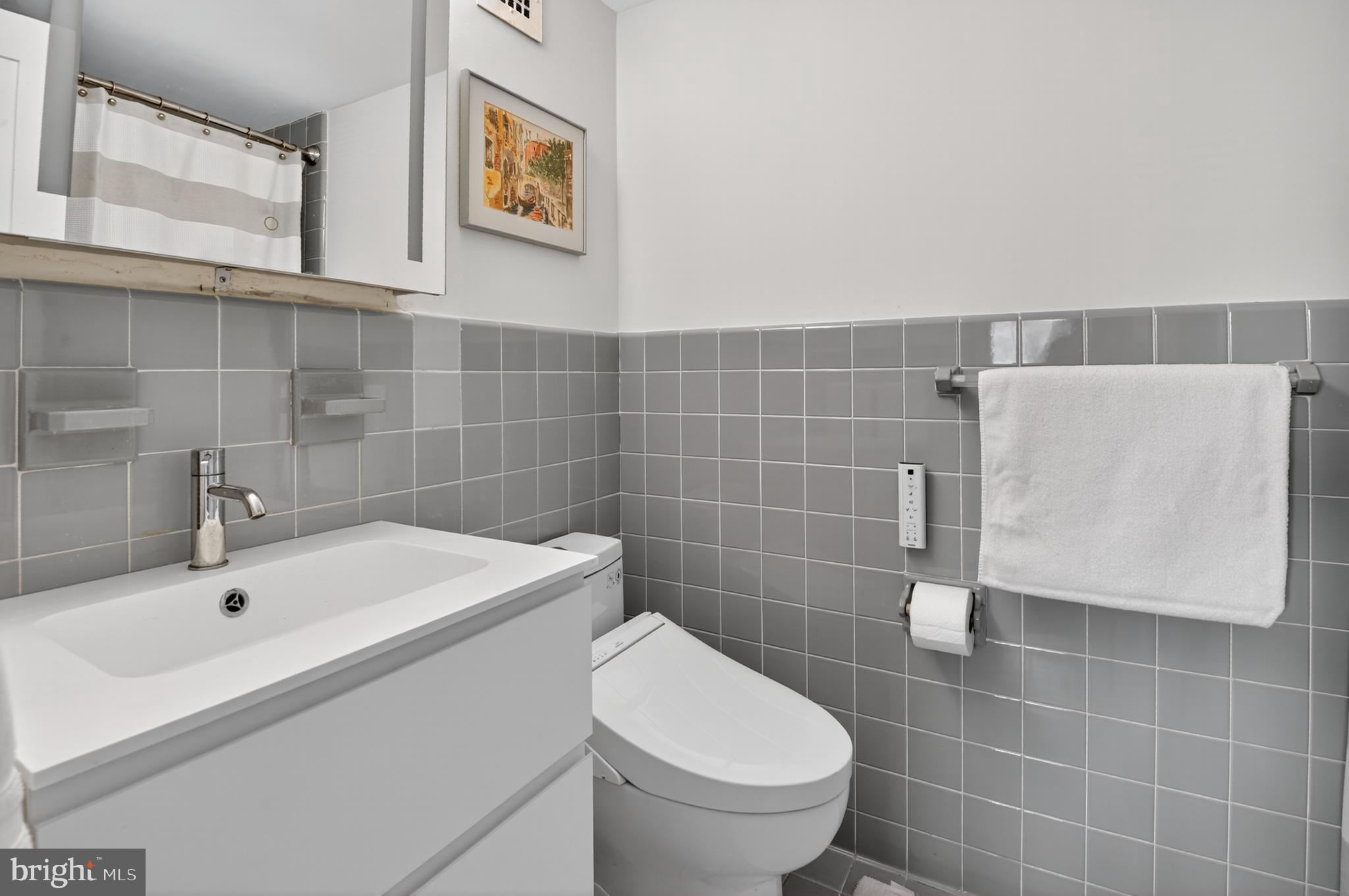 5100 Dorset Avenue, Unit 314 Chevy Chase, MD 20815 - Photo 21 of 30 a bathroom with a sink a toilet and mirror