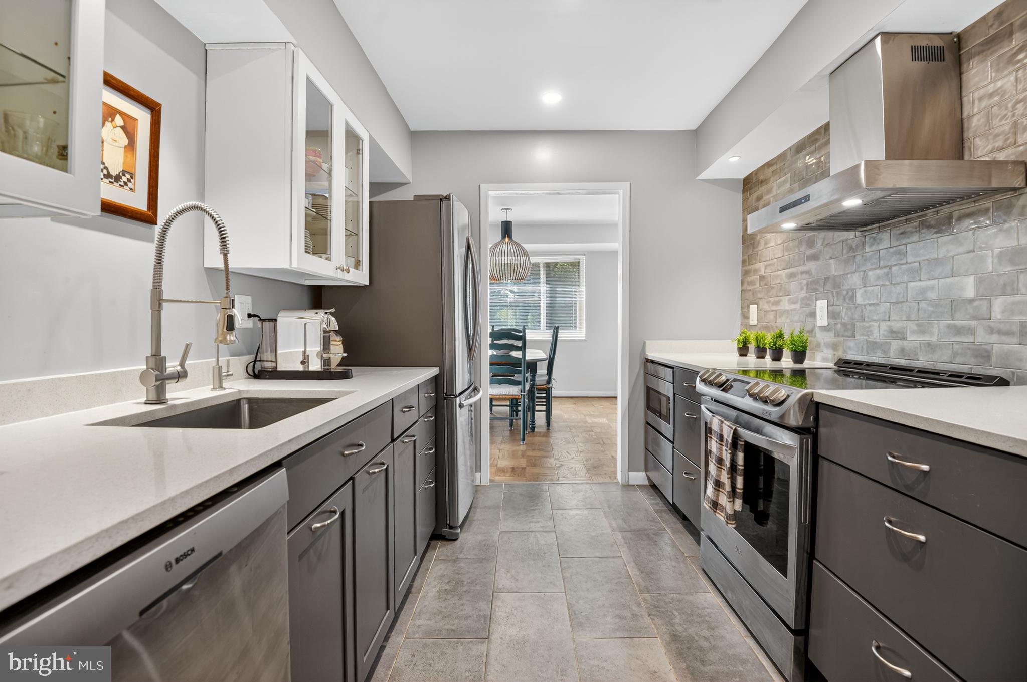 5100 Dorset Avenue, Unit 314 Chevy Chase, MD 20815 - Photo 4 of 30 a kitchen with stainless steel appliances granite countertop a sink and cabinets