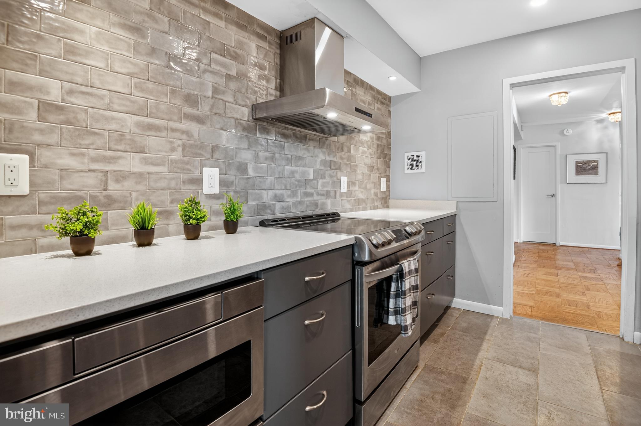 5100 Dorset Avenue, Unit 314 Chevy Chase, MD 20815 - Photo 6 of 30 a kitchen with stainless steel appliances a sink stove and cabinets