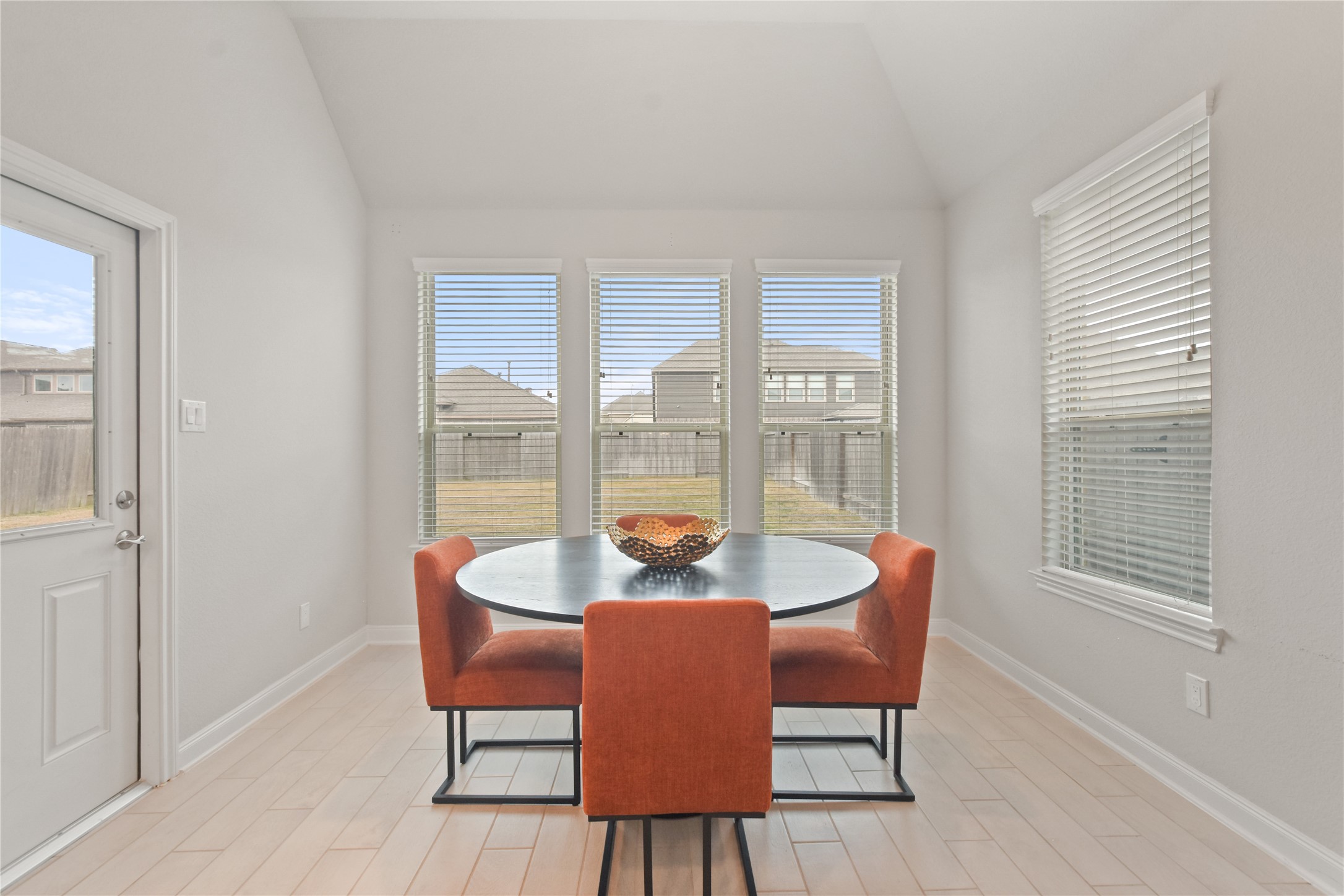 24727 Horsetooth Dr Spring Spring, TX 77373 - Photo 9 of 27 Start your mornings bathed in natural light, sipping coffee in this bright and airy breakfast nook. With stunning backyard views, this space is perfect for slow mornings, family meals, and conversations that linger long past breakfast.