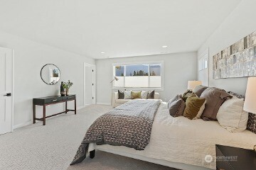 33632 Northeast 42nd Street Carnation, WA 98014 - Photo 20 of 28 a bedroom with a bed a mirror and lamp