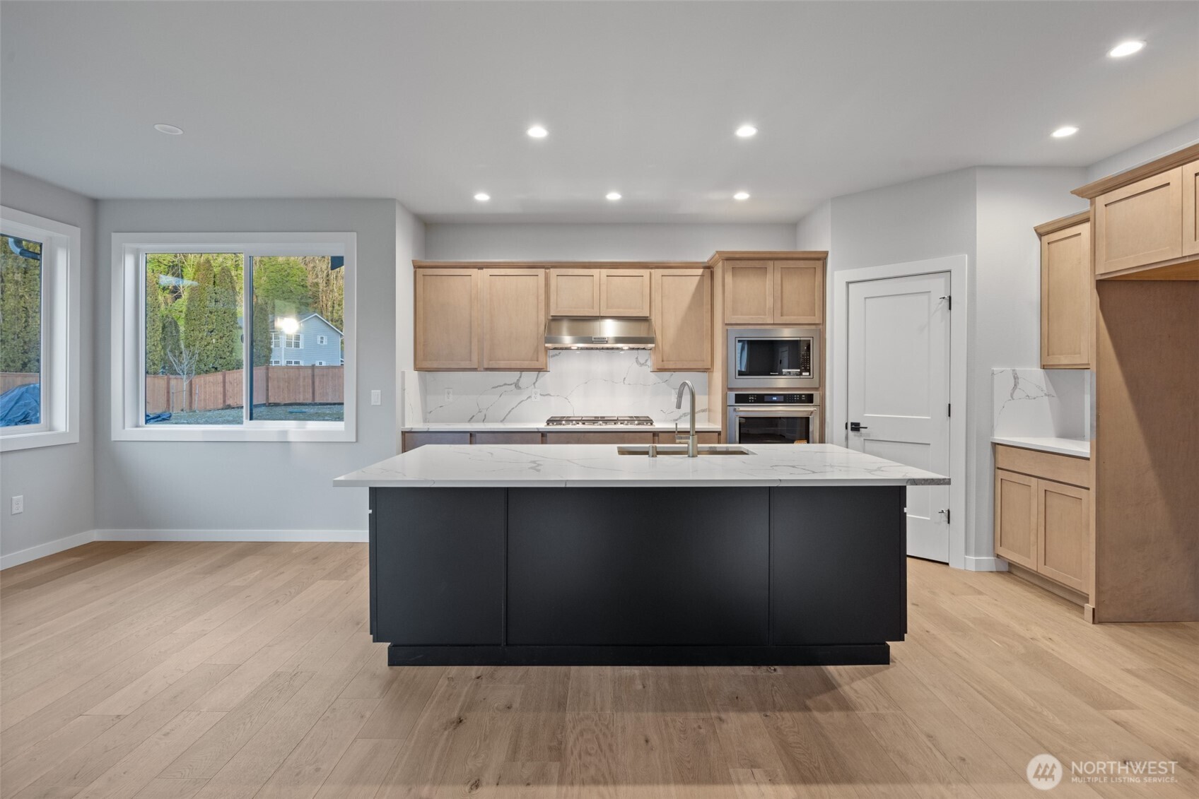 33632 Northeast 42nd Street Carnation, WA 98014 - Photo 9 of 28 a large kitchen with kitchen island a large counter top and stainless steel appliances