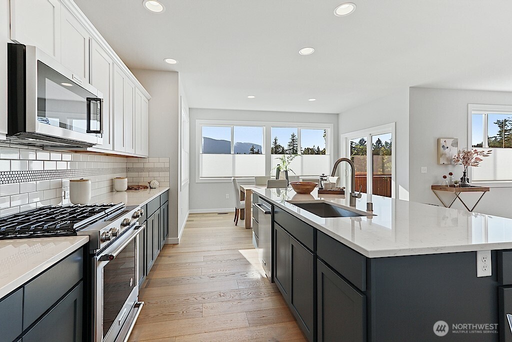 33632 Northeast 42nd Street Carnation, WA 98014 - Photo 10 of 28 a kitchen with stainless steel appliances a sink stove top oven and cabinets
