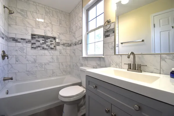 a bathroom with a sink a toilet and bathtub