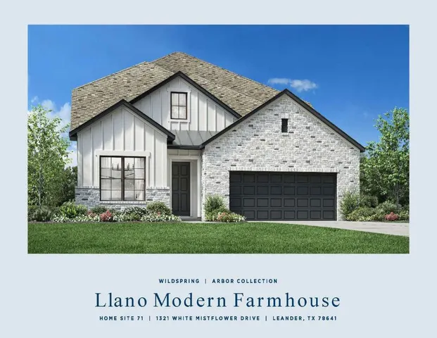 a view of a house with a small yard and garage
