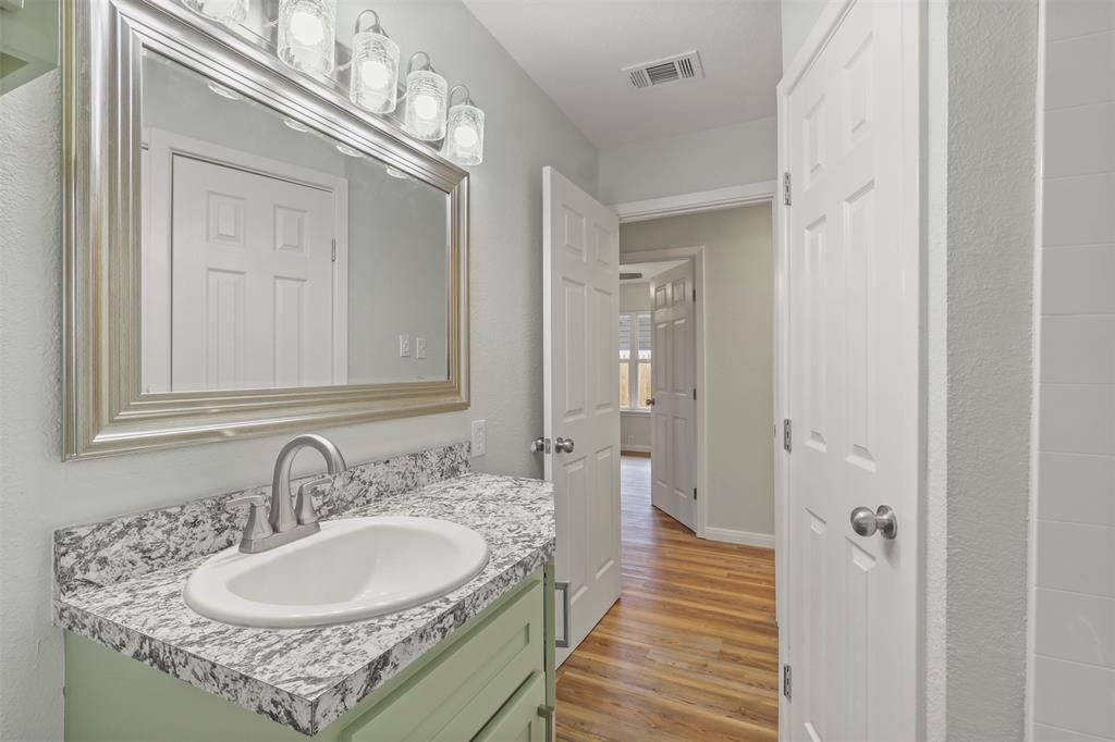 732 Bullock Street Denison, TX 75020 - Photo 16 of 29 a bathroom with a sink double vanity and a mirror