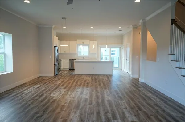 a view of kitchen and hall with wooden floor