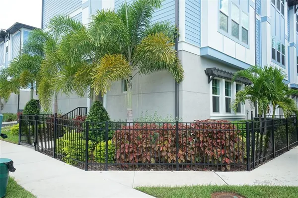 a view of a house with a yard and potted plants