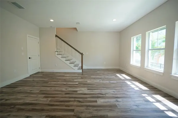 a view of entryway and hall with wooden floor