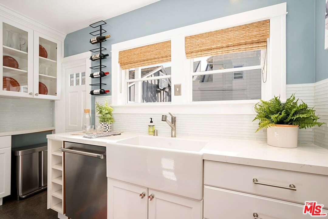 216 West Channel Road Santa Monica, CA 90402 - Photo 14 of 37 a kitchen with a sink a potted plant and a window
