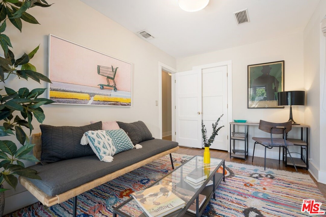 216 West Channel Road Santa Monica, CA 90402 - Photo 22 of 37 a living room with furniture and wooden floor