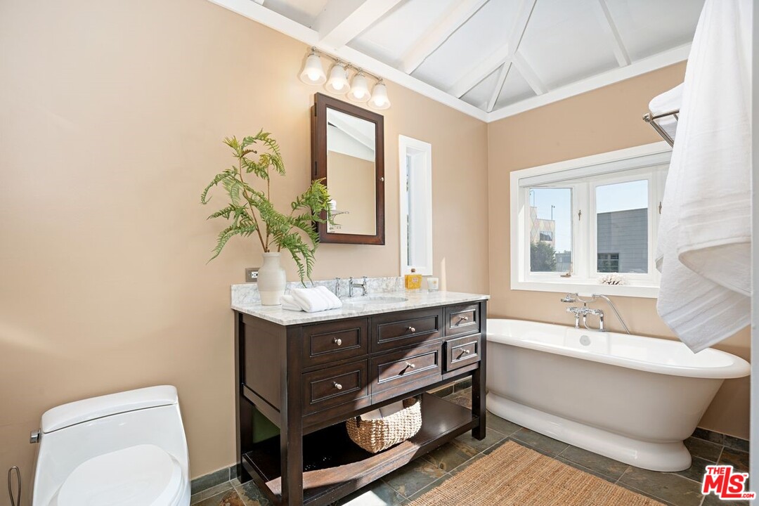 216 West Channel Road Santa Monica, CA 90402 - Photo 34 of 37 a bathroom with a sink mirror vanity and toilet