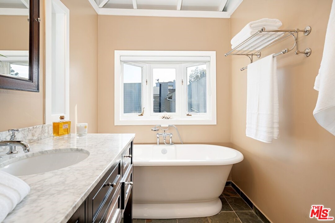 216 West Channel Road Santa Monica, CA 90402 - Photo 35 of 37 a bathroom with a sink and a mirror