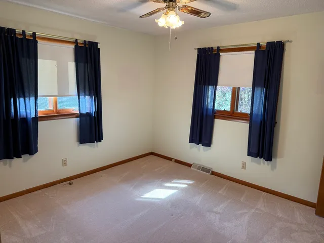 a bathroom with a sink a toilet a mirror and shower