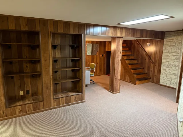 an empty room with furniture and a window