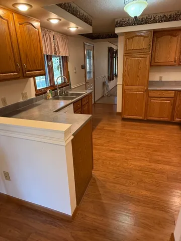 a kitchen with a refrigerator sink and cabinets