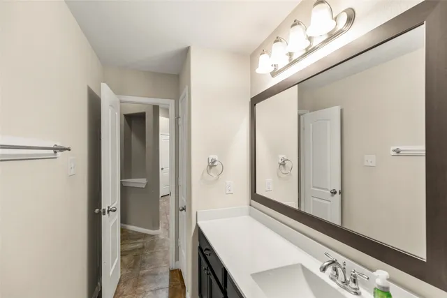 a bathroom with a sink a mirror and a shower